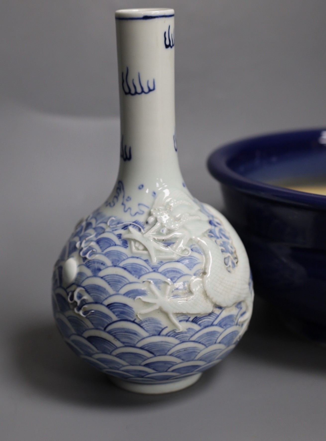 A Chinese blue and white ‘dragon’ bottle vase and a large blue glazed censer, diameter 23cm